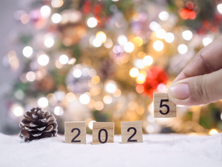 Close up of number 2025 and Christmas decorations with Christmas light background.