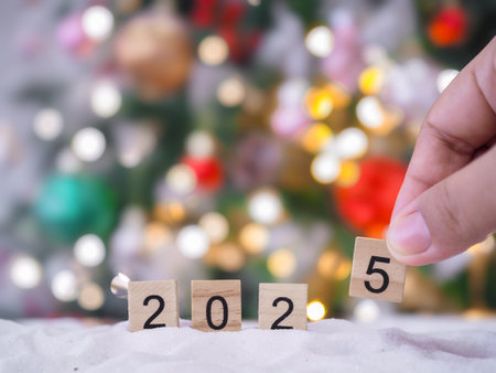 Close up of number 2025 and Christmas decorations with Christmas light background.の写真素材