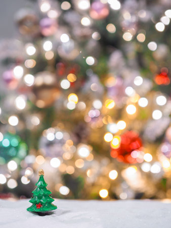 Close-up of tiny pine trees with Christmas light backgroundの写真素材