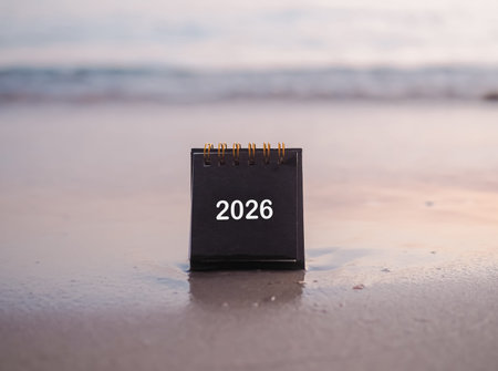 Close up 2026 desk calendar on the beach in the sunset time. Resolution, Goal, Action, Planning, and...