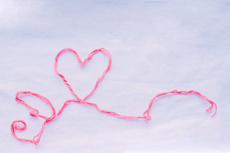 Heart-shaped thread on a white background. Valentine's Day.の写真素材
