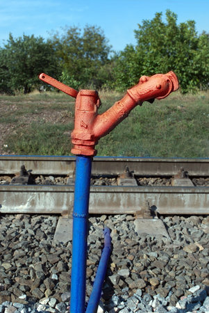 Old fire hydrant near the railsの写真素材