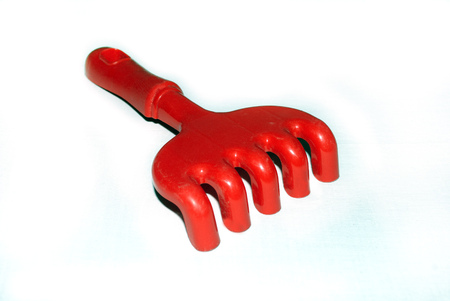 red, plastic rakes childrens for children to playの写真素材