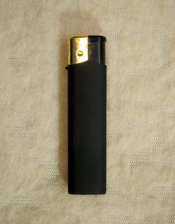 gas lighter of black color on a light backgroundの写真素材