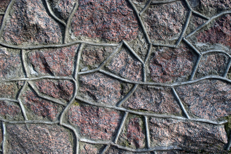 Old granite stone wall with cement seamの写真素材