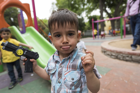 Istanbul, Turkey. May 21, 2016. A kid holding a toy gun challenging the camera.のeditorial素材