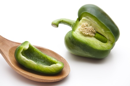 Green paprika on wooden spoonの写真素材
