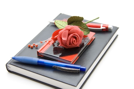 Ballpoint pen with rose on bookの写真素材