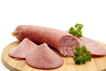 Garlic salami on wooden plateの写真素材