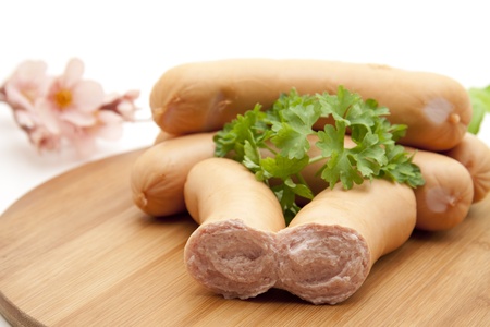 Frankfurter on wooden plateの写真素材