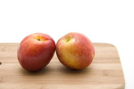 Nectarine on wooden plate