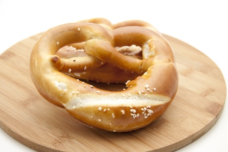 Salt pretzel on wooden plateの写真素材