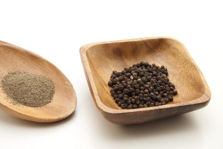 Peppercorn in wooden bowl
