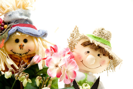 Straw dolls with geraniumの写真素材