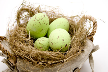 Easter eggs in the basket with straw