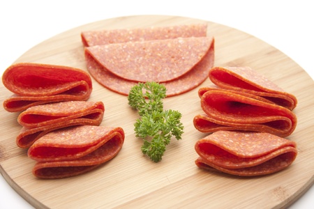 Salami on wooden plateの写真素材