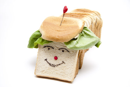 Toast bread with face and salad leafの写真素材
