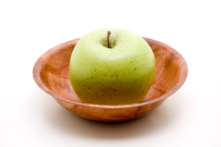 Green apple in wooden peelの写真素材