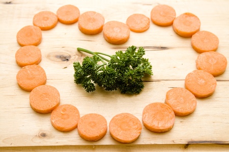 Carrot heart with parsleyの写真素材