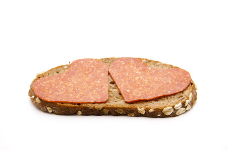 Heart salami on breadの写真素材