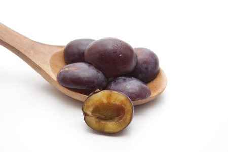 Plums on wooden spoonの写真素材