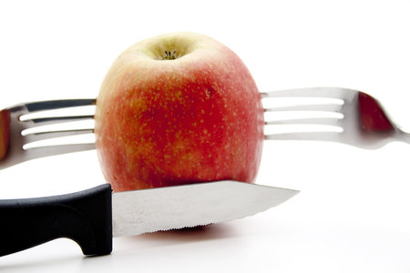 Apple with knife and fork