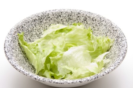 Iceberg salad in porcelain bowlの写真素材