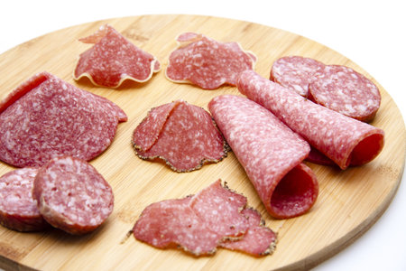 Salami on wooden plate