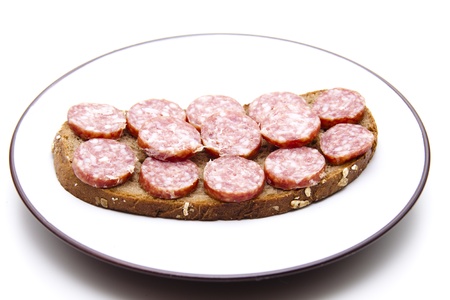 Farm smoked sausage spread on slice of breadの写真素材