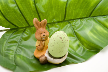Easter bunny with Easter egg on leaf