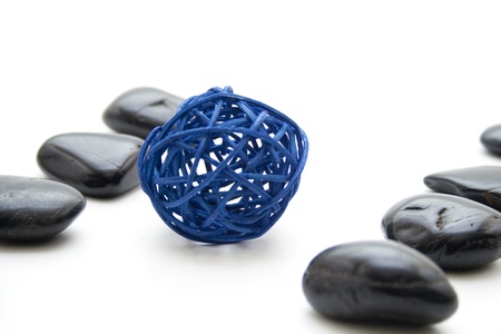 Black stones with straw ballの写真素材