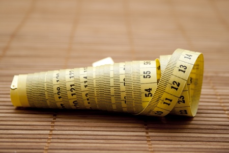 Measuring tape on brown baseの写真素材