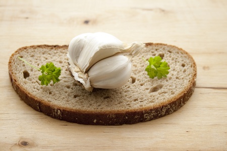 Garlic on slice of bread with parsley の写真素材