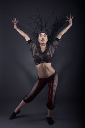 dancing asiatic girl, studio shot, gray backgroundの写真素材