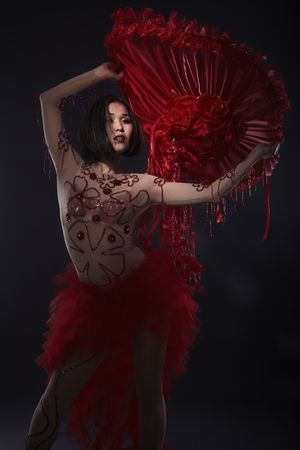 Young model posing in dancing outfit, red hatの写真素材