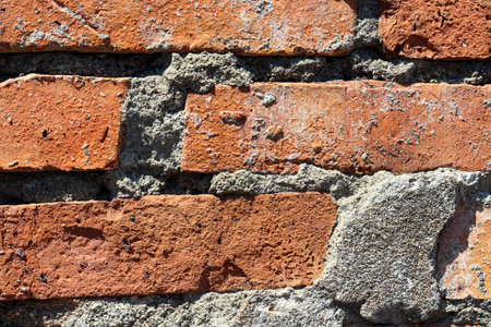 Old weathered orange brown brick background with gray cement elements