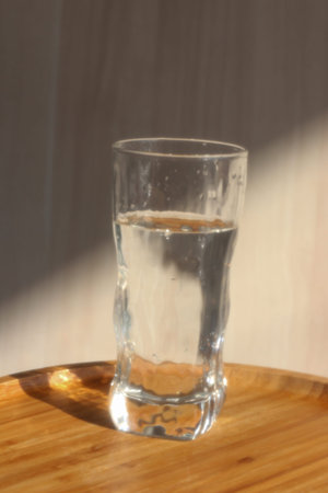 A glass of water in the morning lights and shadows. Healthy lifestyle morningの写真素材
