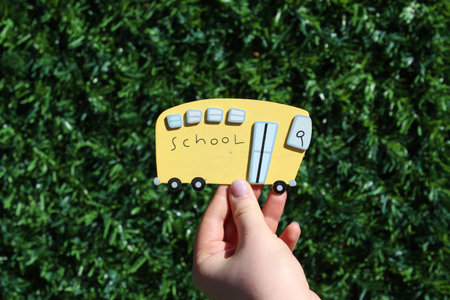 School bus symbolic figure on the textured green background.