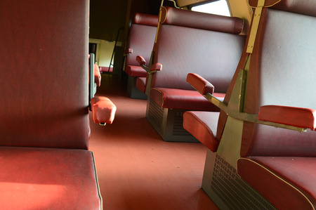 View at old vintage train interior with burgundy leather seatsの写真素材