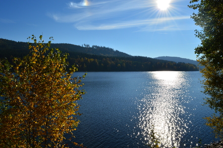 Autumn trees near beautiful blue lakeの写真素材