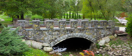 Stone arched bridge in the park Pheophany