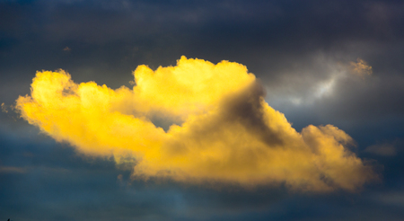 Yellow rain cloud against a stormy sky close upの写真素材