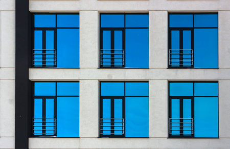 Clouds Reflected in Windows of Modern Office Building