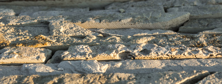 Fragment of artistic wall made with multiple stones.の写真素材