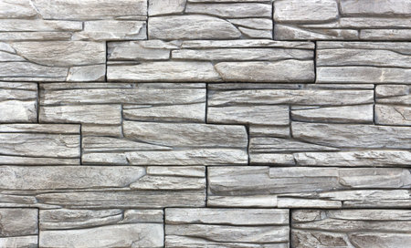 Decorative brick wall from concrete facing tiles as background or texture