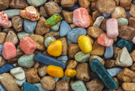 Polished colored marble pebbles and semi-precious stones backgroundの写真素材
