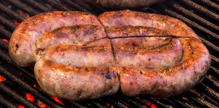 Grilling sausages on barbecue grill. Selective focus