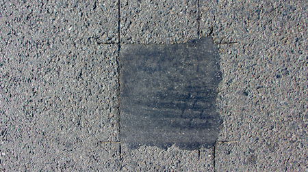 The texture of asphalt on which there are cracks close upの写真素材