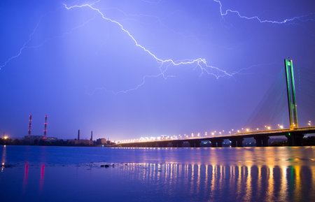 Lightning in the night sky above the city.の写真素材