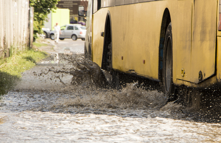 motion car rain big puddle of water spray from the wheels.の写真素材